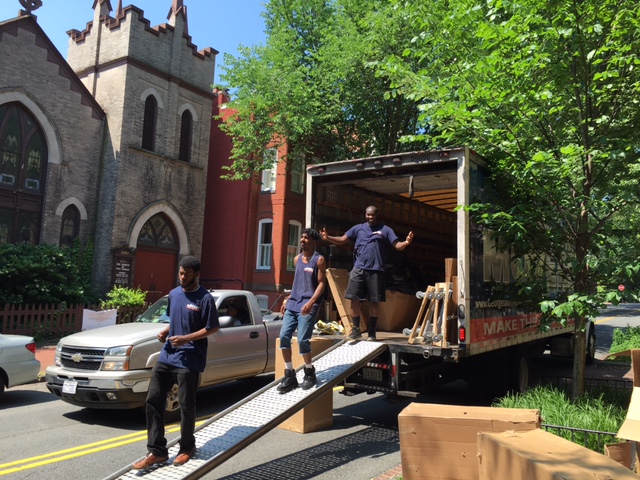 Georgetown Moving and Storage employees loading a large moving truck with boxes and furniture.